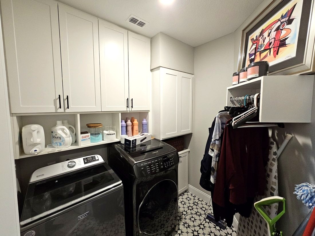 Custom laundry room with cabinetry and folding counter