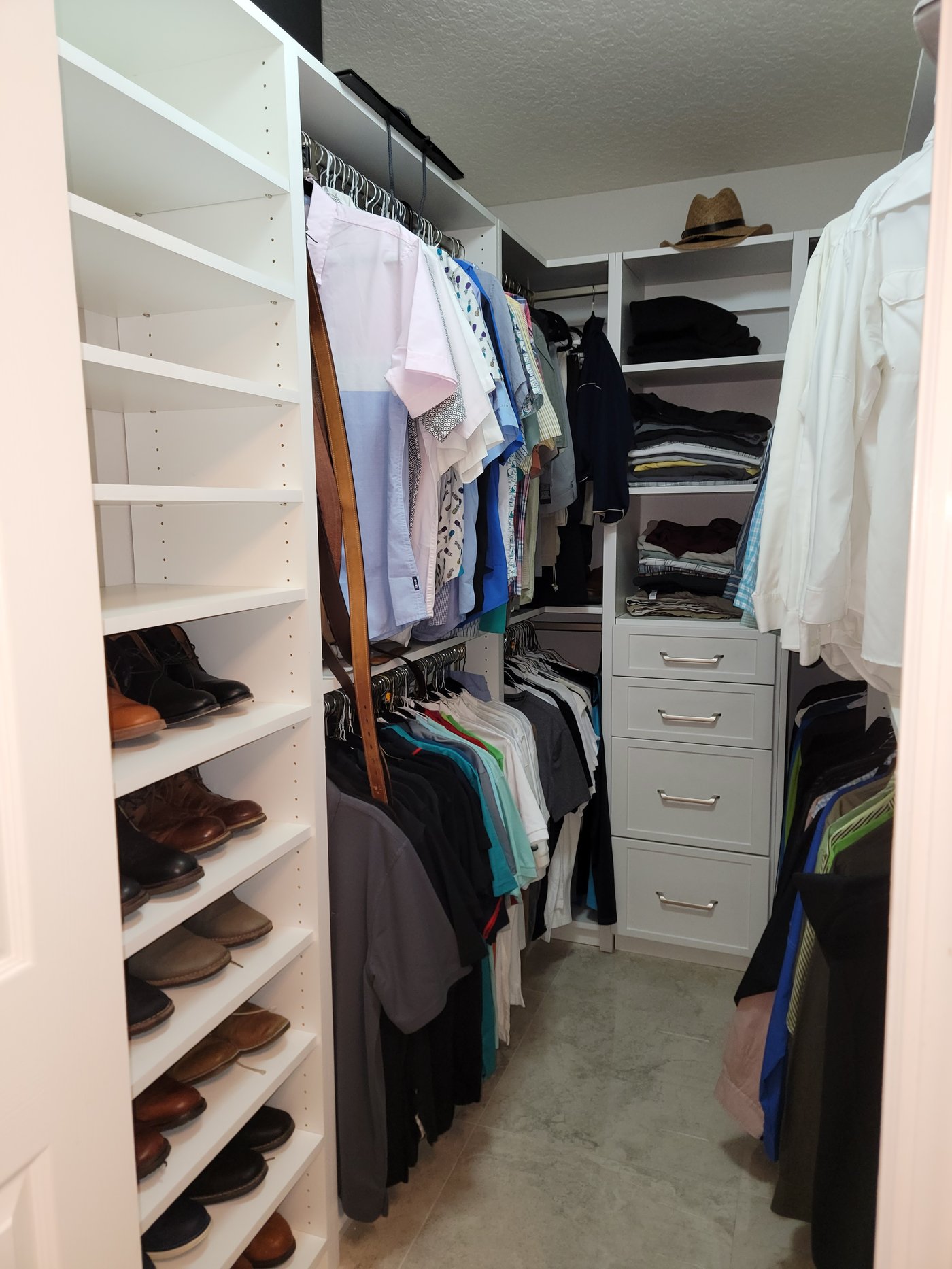 Walk-in closet with clothing stacks and drawers by Create More Space