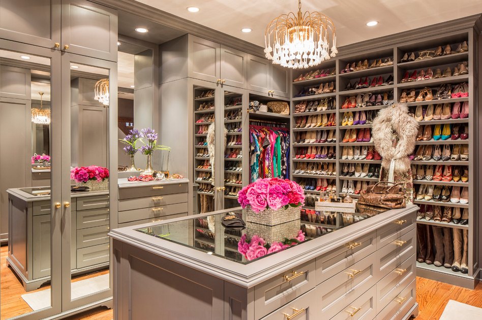 Luxury custom walk-in closet with center island, chandelier and display shelving by Create More Space