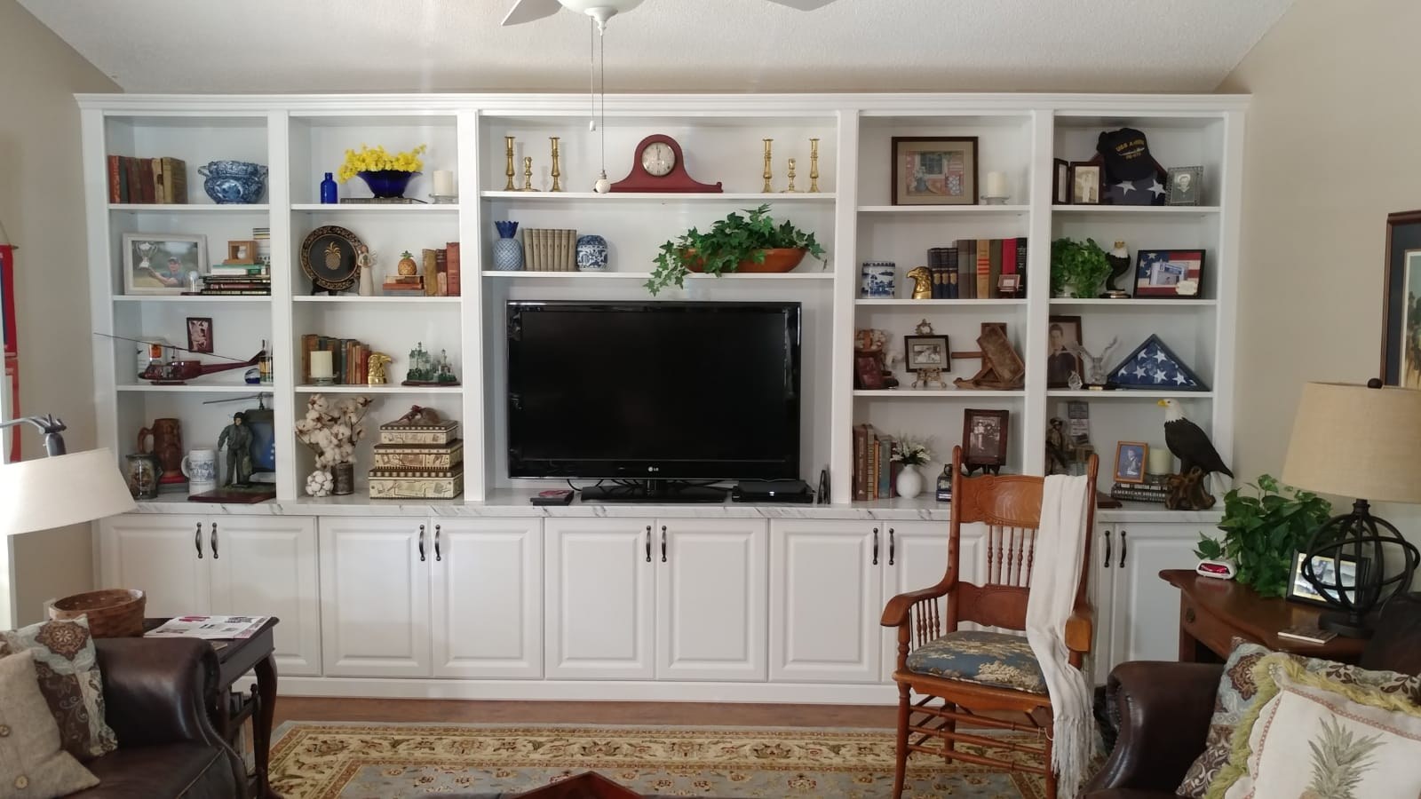White entertainment built-in with bookshelves and TV by Create More Space