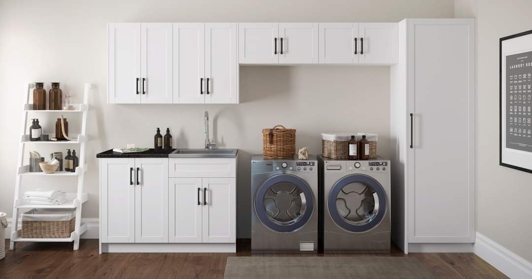 Custom laundry room with cabinetry and folding counter by Create More Space