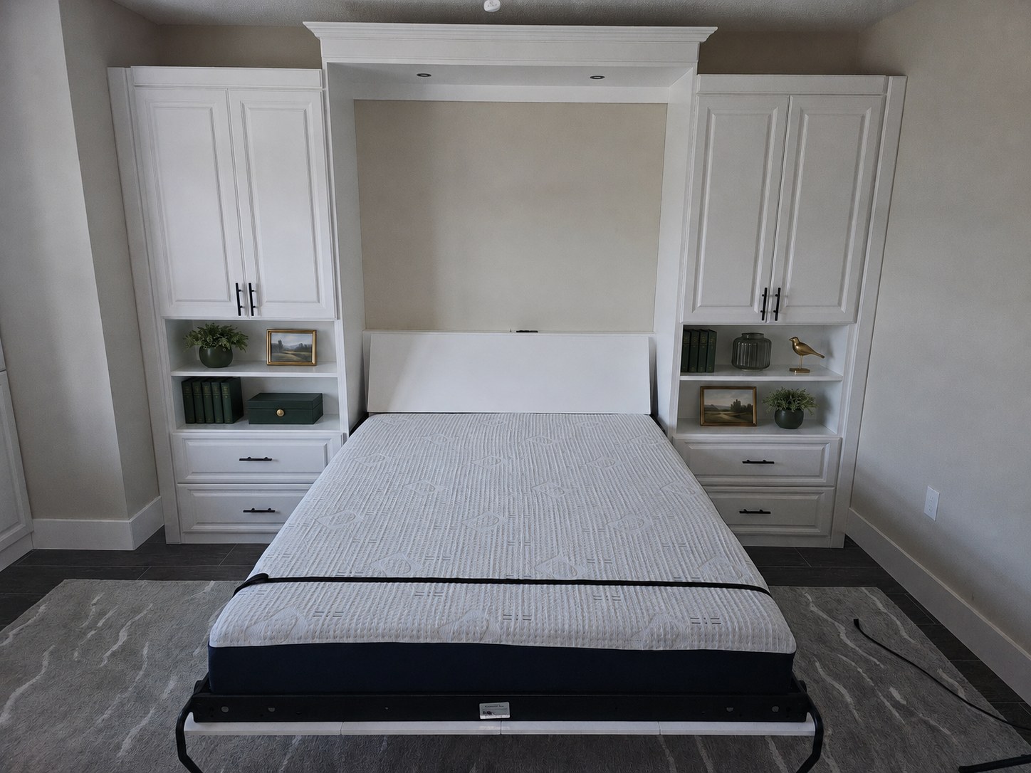 White wall bed shown open with flanking cabinets by Create More Space