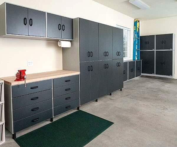 Custom garage with cabinetry, workbench and overhead storage