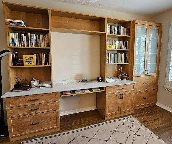 Home office with built-in desk, hutch and glass cabinets by Create More Space