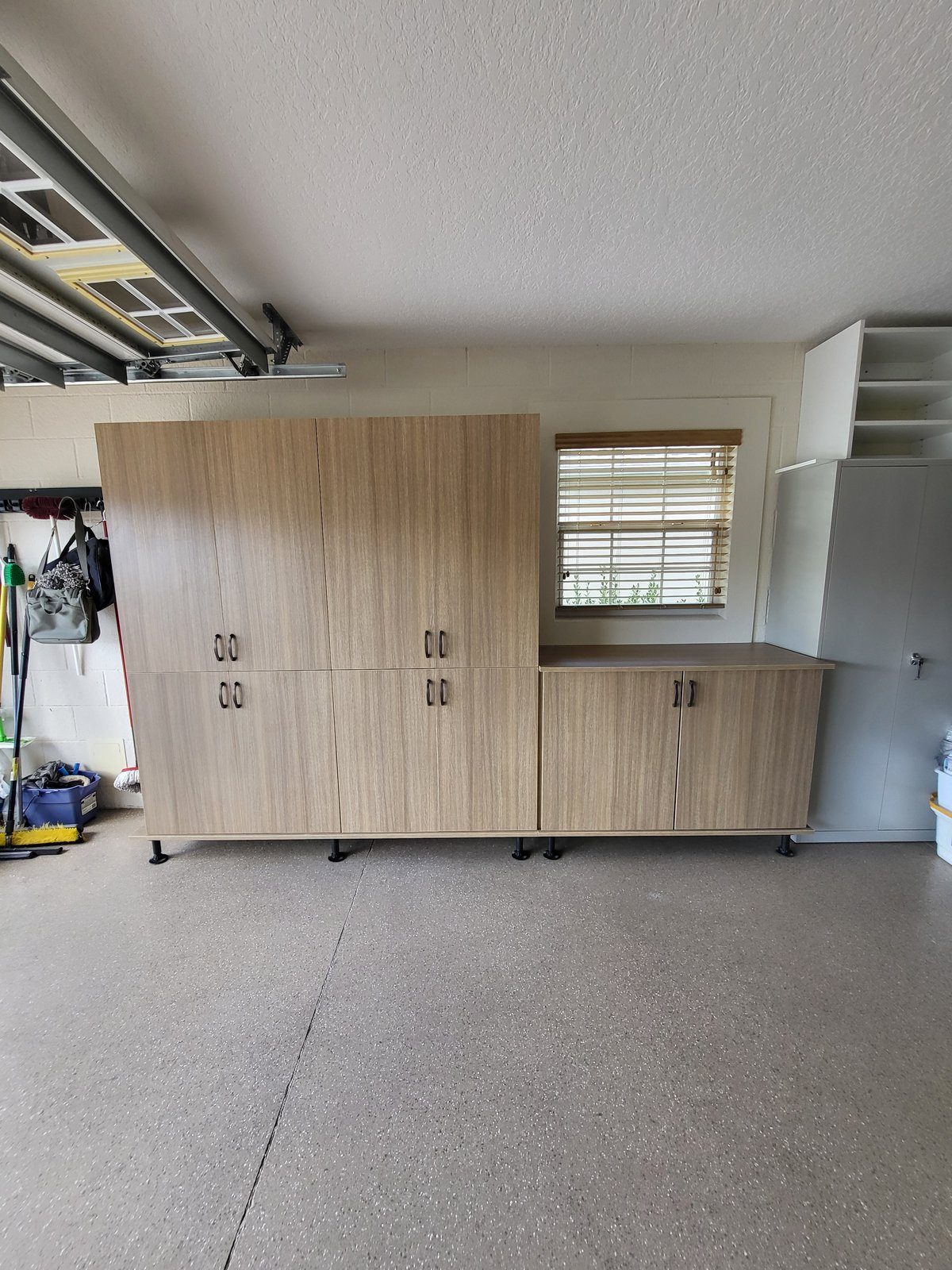 Custom garage storage cabinets in warm finish by Create More Space