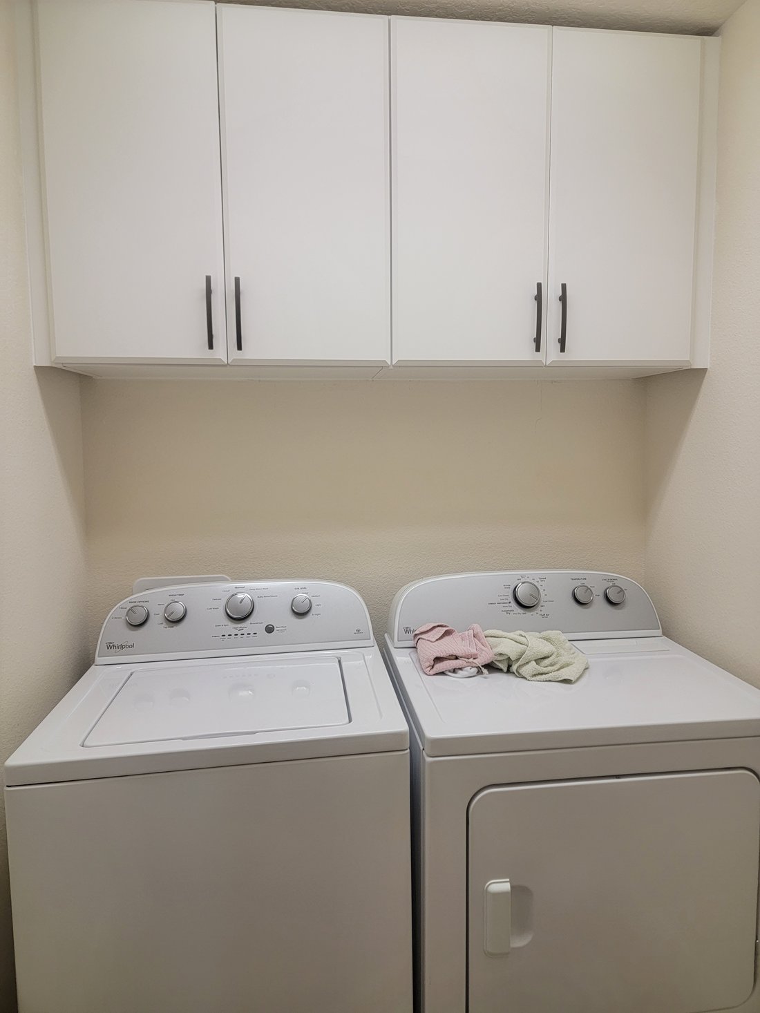 Laundry room with cabinetry and folding station