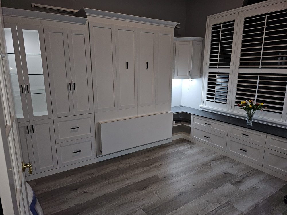 White home office with built-in desk and plantation shutters