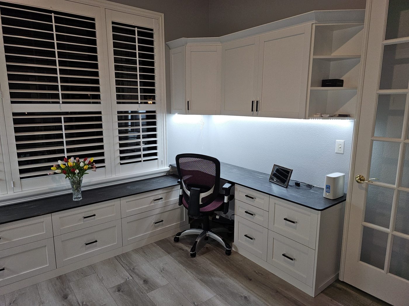 Home office with corner desk and upper cabinetry
