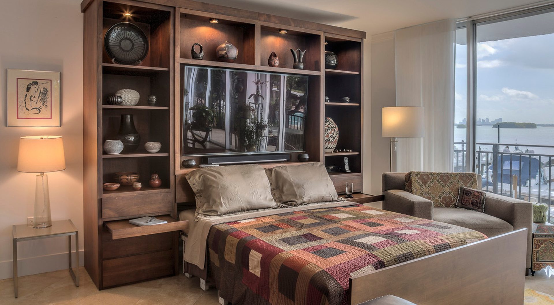 Zoom-Bed lowered from a custom entertainment wall with a waterfront view